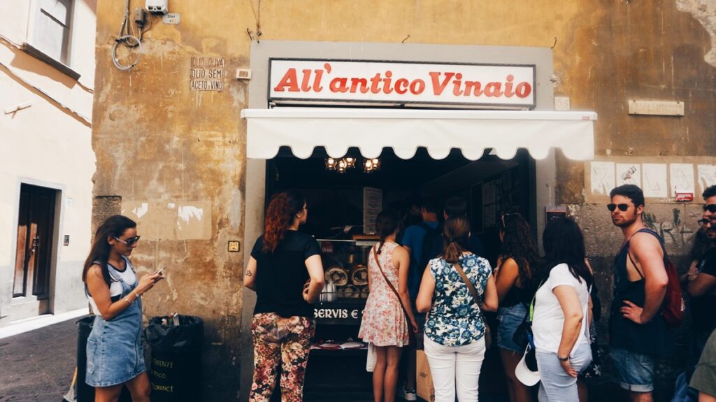 People waiting in a line to All'Antico Vinaio in Florence