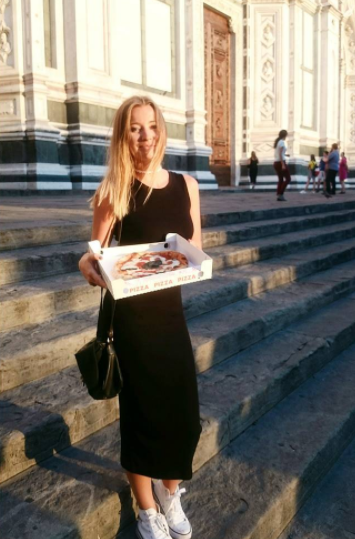 Girl with pizza in front of Santa Croce Church 